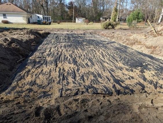 Septic field installation with geotextile fabric covering during construction