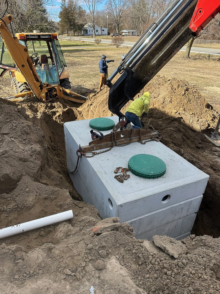 Septic tank installation with excavator for a residential property in Belleville Michigan